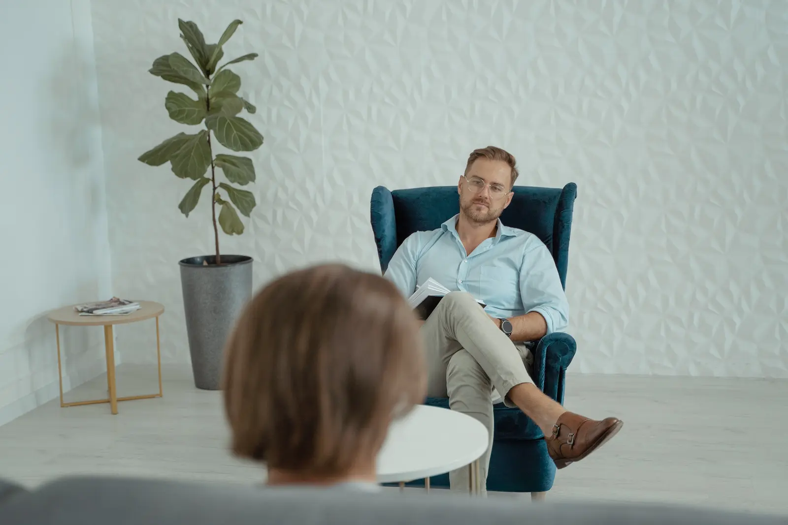 A therapist listening to a client during a one-on-one counseling session