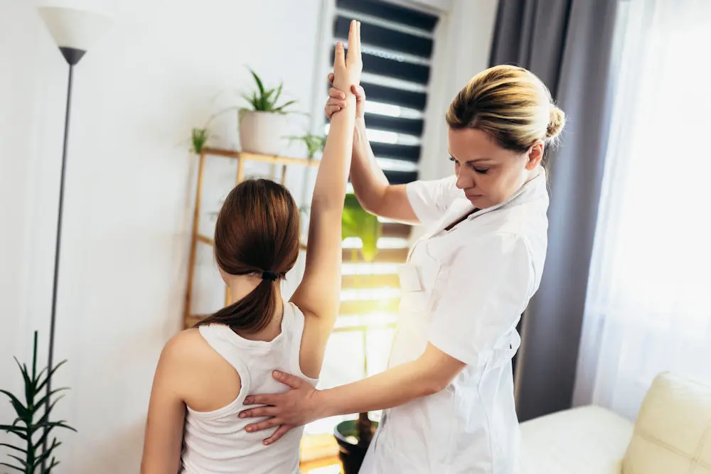 A practitioner guiding a client through stretching and bodywork