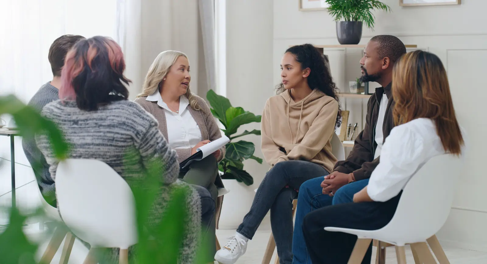 A therapist leading a small group therapy session
