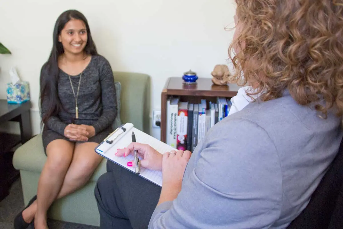 A clinician meeting one-on-one with a patient at the Neuroscience Institute