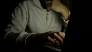 man using computer at night