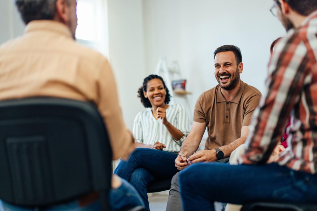 People enjoying a group therapy session through Ambrosia Treatment Center.